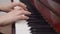 Musician woman playing piano keys with hands. Artist is playing the piano. Keyboard musical instrument, close up