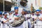 Musicians in a band are playing brass instruments during the pre-carnival Fuzue parade