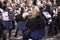 Musicians from a brass band playing outside in a town market square.