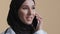 Muslim arabian young female doctor intern woman surgeon practitioner wear medical coat hijab talk by cellphone islamic