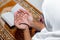 Muslim Asian women raise their hands to pray on the mat at home.