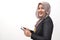 Muslim business woman wearing hijab holds and using smart phone or digital tablet. Successful businesswoman entrepreneur and