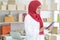 Muslim business woman working in office, Modern Muslim Business Woman, Small business, Online trading and shipping services.