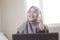 Muslim Businesswoman Talking on Phone in Office, Smiling Expression