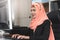 Muslim businesswoman talking and solving problem for client via telephone support service