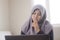 Muslim Businesswoman Working on Laptop at Home, Thinking Gesture