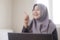 Muslim Businesswoman Working on Laptop at home, Thinking Gesture