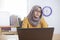 Muslim Businesswoman Working on Laptop at the Office, Thinking Gesture