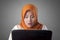 Muslim Businesswoman Working on Laptop Shocked Stunned gesture