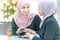 Muslim Businesswomen with their smartphone during their coffee break
