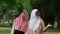 Muslim careful caregiver or nurse taking care of the patient in the hospital park. Happy Muslim mother in hijab hugging daughter.