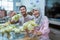 muslim couple asian making ketupat rice cake at home using palm leaf