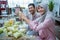 muslim couple making ketupat for idul fitri traditional delicacy