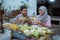 muslim couple making ketupat for idul fitri traditional delicacy