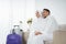 Muslim couple sit wearing white traditional clothes before umrah