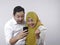 Muslim Couple Surprised when Looking at Smart Phone, Winning Gesture