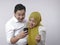 Muslim Couple Surprised when Looking at Smart Phone, Winning Gesture