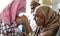 Muslim daughter kisses her mother`s hands