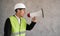 Muslim engineer with megaphone. Advertising of construction services. Foreman organizes the work. Builder or repairman
