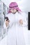 Muslim entrepreneur using a mobile phone