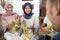 muslim family and friend making ketupat for eid fitr mubarak