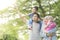 Muslim family looking at something in the park