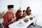 Muslim family pray when breaking fast