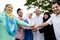 Muslim family stacking hands in the park