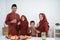 Muslim family stand to drink when breaking fast