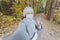 Muslim girl in a medical mask makes a selfie. Portrait of islamic arabian female student in park during a pandemic.