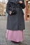 Muslim girl shoots a professional photographer in a blue shawl in a gray coat and pink dress