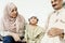 Muslim grandparents with their grandchild