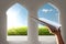 Muslim hands holding quran open in the mosque with garden view from window arches