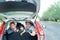 Muslim happy family smile and laugh in car, looks father hand waving goodbye