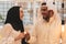 Muslim hijab woman share bitcoin with arabian businessman.