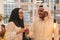 Muslim hijab woman share bitcoin with arabian businessman.