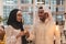 Muslim hijab woman share bitcoin with arabian businessman.