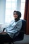 Muslim Hijab woman sitting in the makeup room while staring upwards with a hopeful