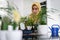 Muslim housewife at home watering the plants