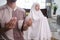 muslim husband and wife praying jamaah together at home