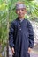 Muslim Indonesian boy dressed in traditional clouting looking at camera