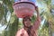 Muslim Indonesian woman carry a basket on her head