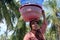 Muslim Indonesian woman carry a basket on her head in Gili Air Island Indonesia