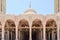 Muslim Islamic Arabian mosque made of white brick for praying architectural construction with arches, domes and carved triangular