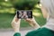 Muslim lady sitting on bench at park, having a video call with her office female Arab colleague