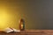 Muslim lamp, prayer beads and Koran on wooden table against dark background.