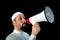 Muslim man with beard shouting through megaphone calling for Hajj