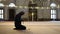 Muslim man at the mosque, worship with prayer beads or rosary