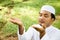 Muslim man praying outdoor. Nature landscape.Muslim man praying on green meadow.Muslim prayer,the light of faith, hope, faith.