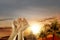 Muslim man praying with prayer beads on his hands and mosque with palm trees